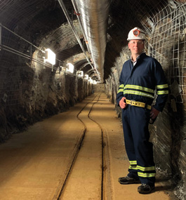 Bjoern Penning, wearing miner's helmet, standing inside an underground shaft.